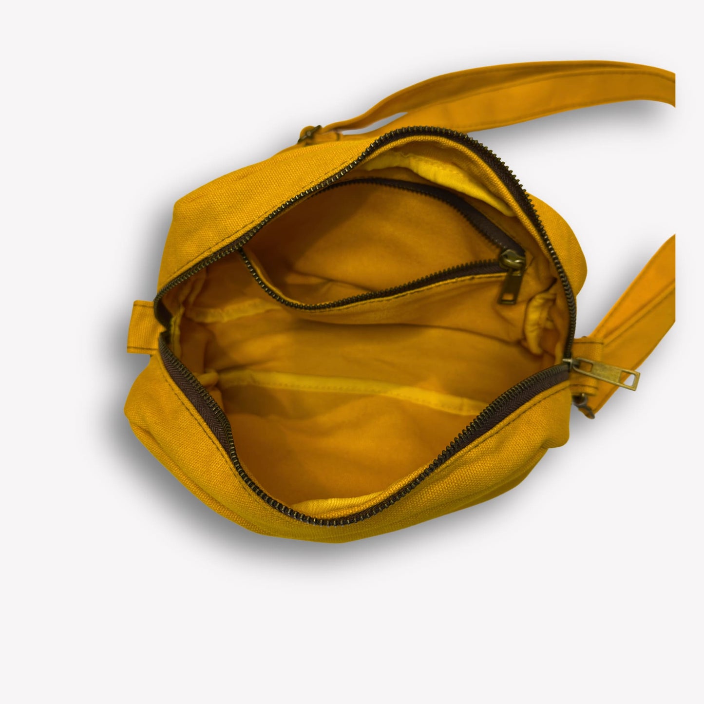 Inside view of Wattle Yellow Crossbody Bag by Wandering Sol showing large phone sized inner pocket – made from recycled canvas with removable strap, can be worn as a clutch or shoulder bag.
