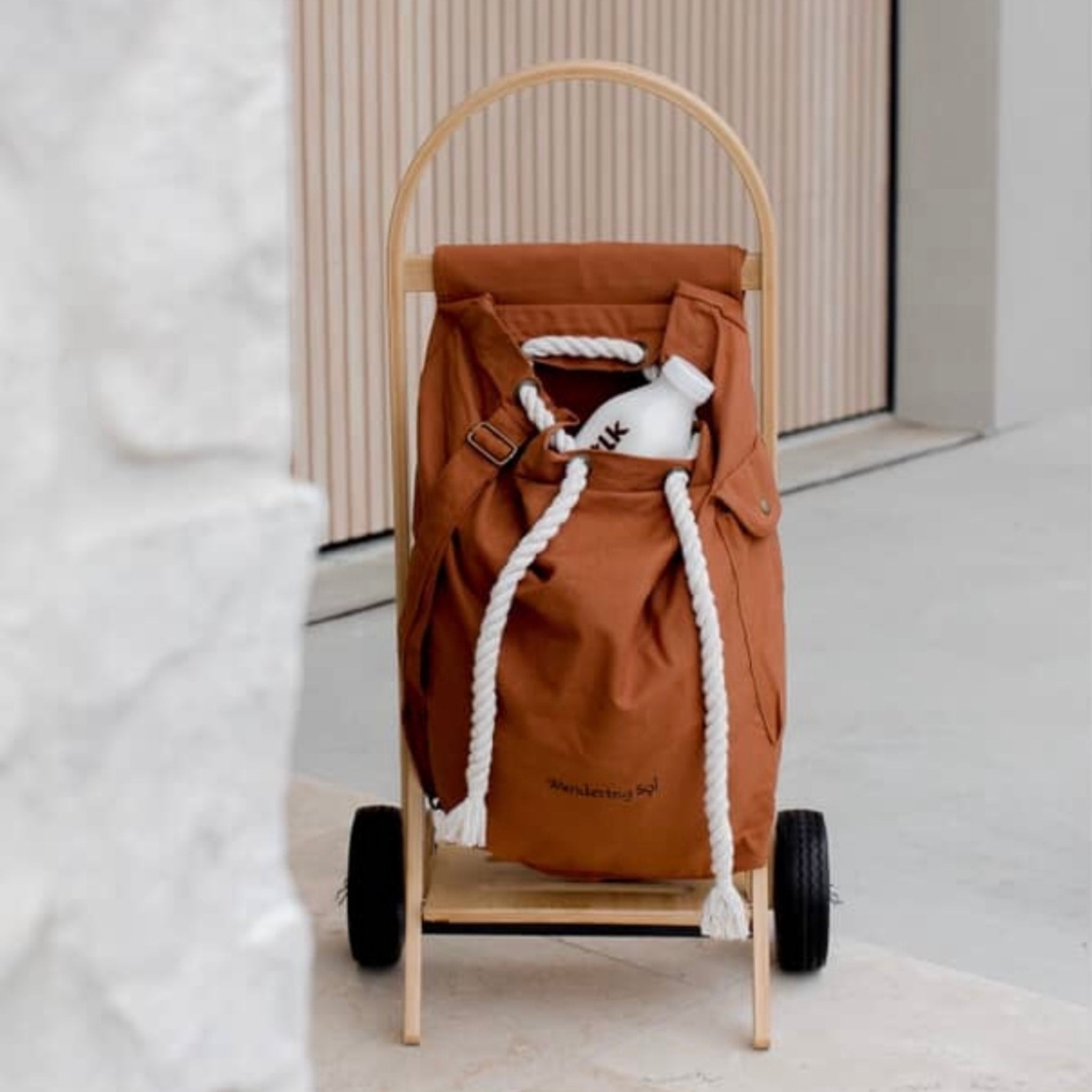 The Nimble Cart in clay brown outside the home