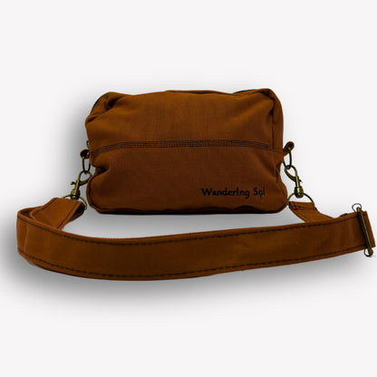 Front view of Clay Brown Crossbody Bag by Wandering Sol showing detachable strap – made from recycled canvas with removable strap, can be worn as a clutch or shoulder bag.