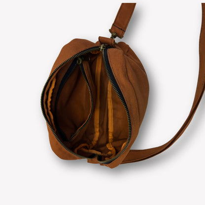 Inside view of Clay Brown Crossbody Bag by Wandering Sol showing large phone sized inner pocket – made from recycled canvas with removable strap, can be worn as a clutch or shoulder bag.