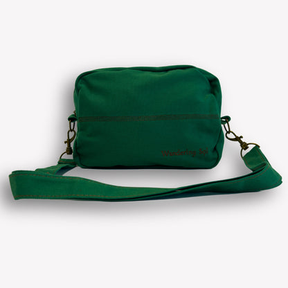Front view of Emerald Green Crossbody Bag by Wandering Sol showing detachable strap – made from recycled canvas with removable strap, can be worn as a clutch or shoulder bag.