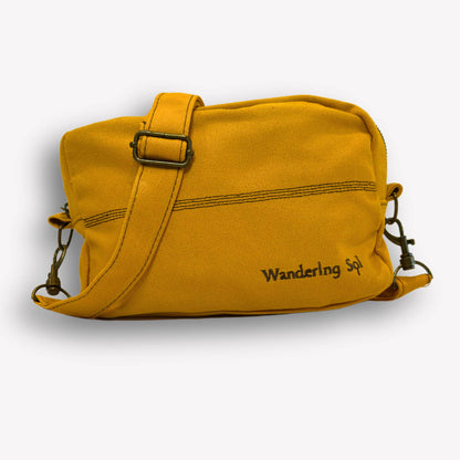 Front view of Wattle Yellow Crossbody Bag by Wandering Sol showing hardware bronze detail  – made from recycled canvas with removable strap, can be worn as a clutch or shoulder bag.