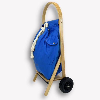 Side profile of Nimble Market Cart showing slim bamboo frame, Ningaloo Blue canvas bag, and new forever wheels