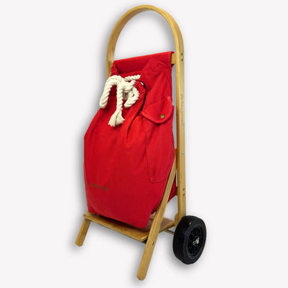 Side profile of Nimble Market Cart showing slim bamboo frame, Pilbara Red canvas bag, and new forever wheels