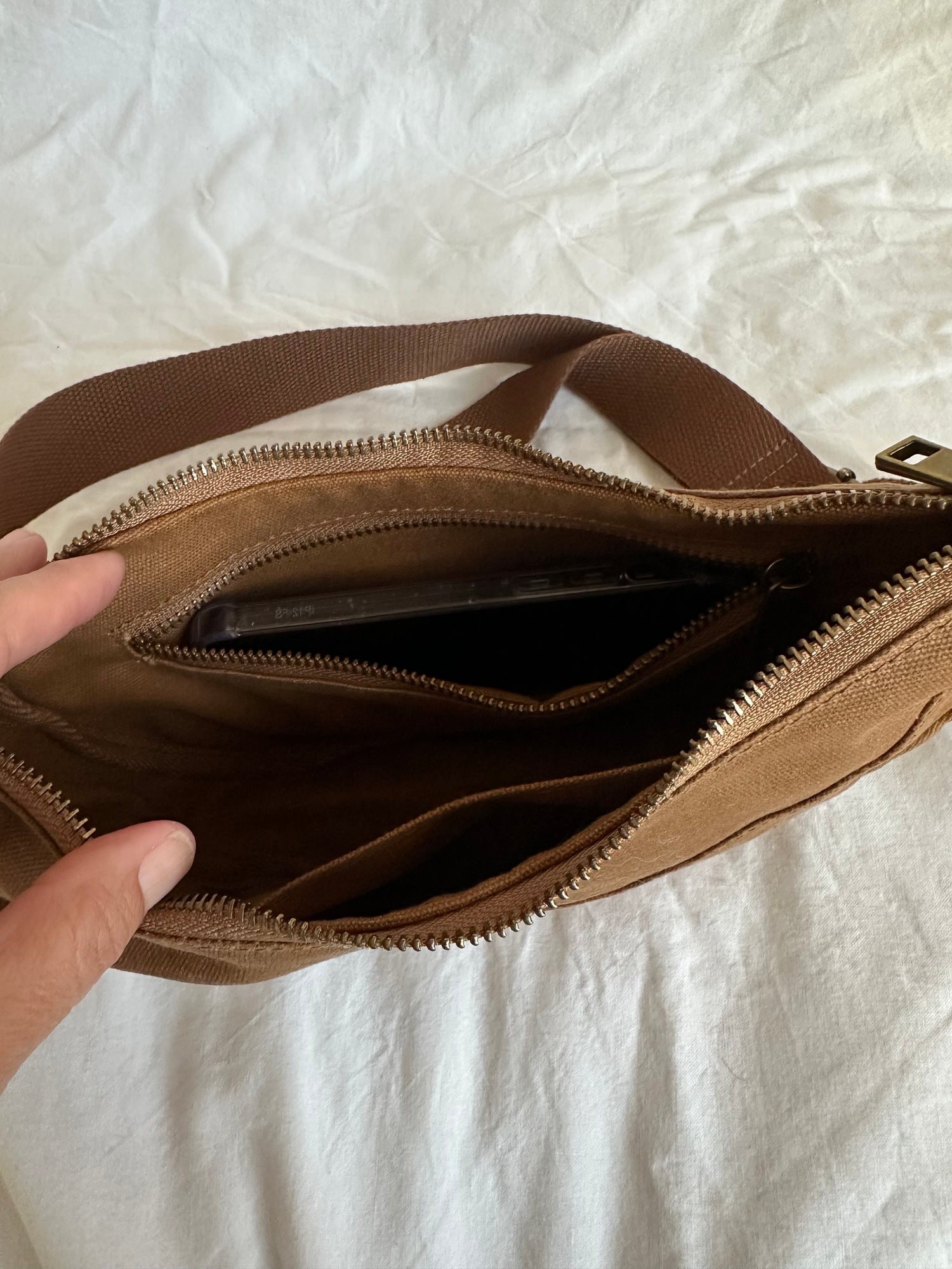 Open Crossbody showing the internal zipped pocket, open pocket and phone capacity.