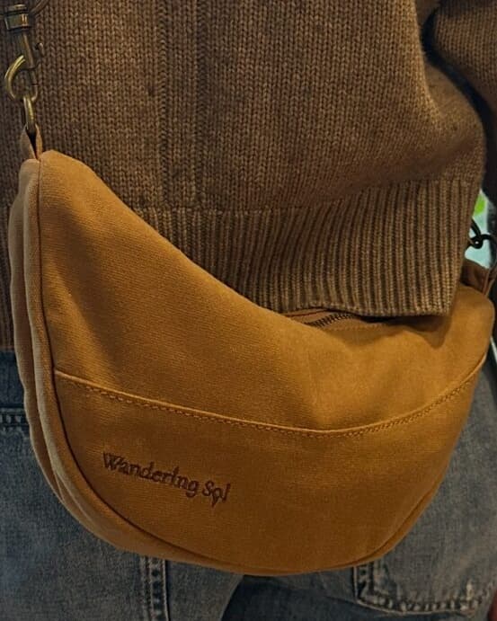 Narelle wearing the Wandering Sol clay waxed canvas Crossbody with a brown jumper